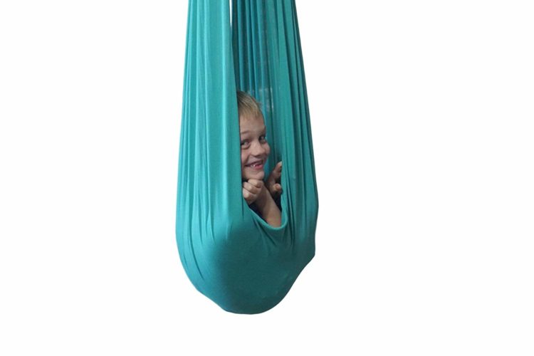 Child inside lycra swing smiling