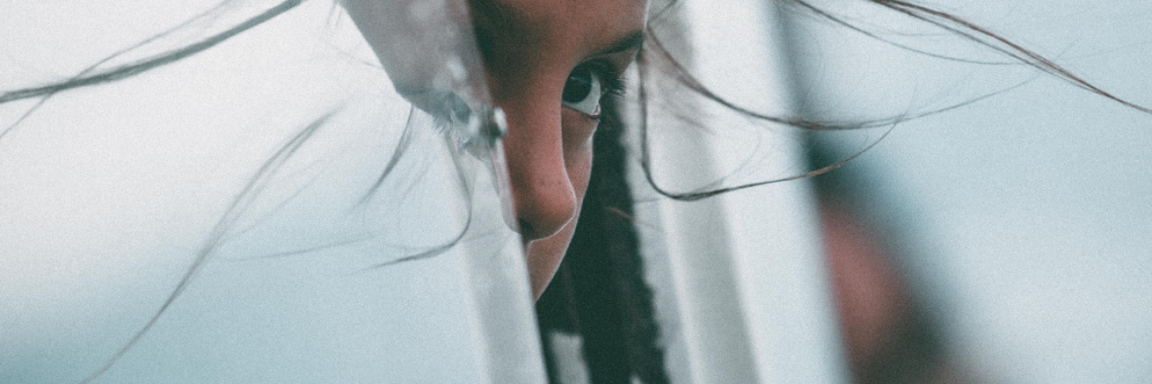 'Embarrassing' Symptoms of Postural Orthostatic Tachycardia Syndrome A young girl peeks out from a small opening where she's hiding, her hair pulled forward in the wind. 12 'Embarrassing' Symptoms of POTS We Don't Talk About