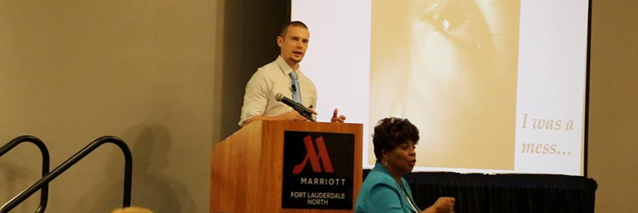 Helping Your Child on the Autism Spectrum Take Risks Russell giving a speech at a podium.