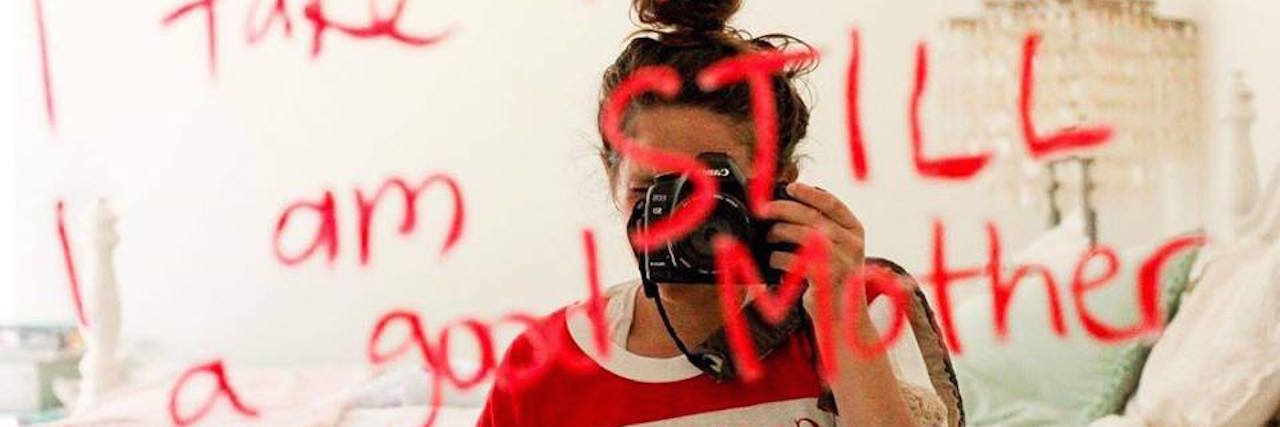 A Letter to Anxiety From an Anxious, Medicated Mom A woman holding pill bottles, taking a mirror selfie. The mirror shows the words: I have anxiety, I take medication and I am still a good mom