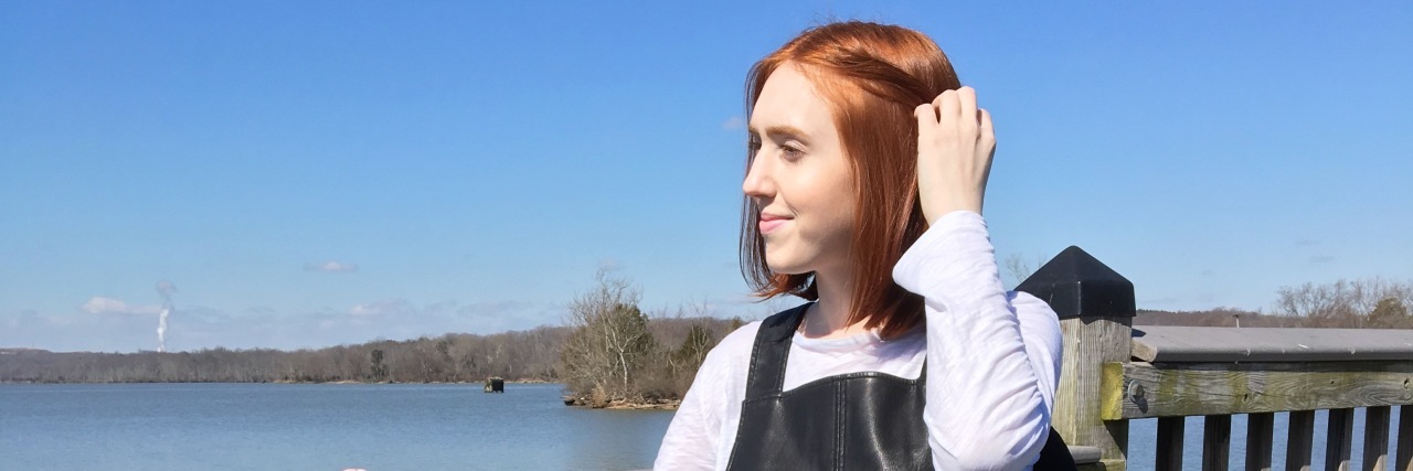 How to Deal With the Uncertainty of Being Chronically Ill Maria smiling as she looks over a bridge