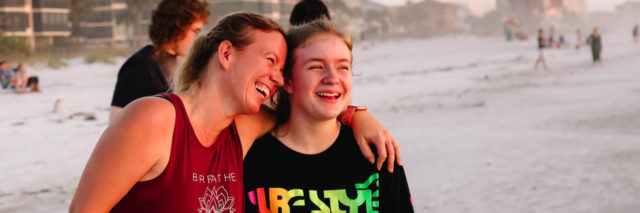 photo of contributor cindy johnson and daughter standing on beach smiling and laughing