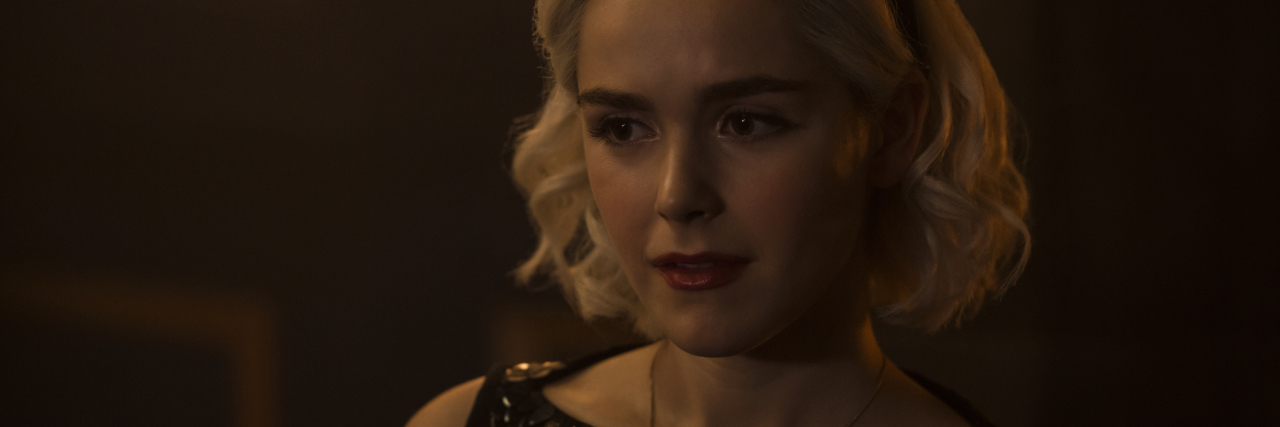 Netflix's 'The Chilling Adventures of Sabrina' Has Suicidal Imagery Image of Sabrina, a young blonde woman with chin-length hair wearing a dress.