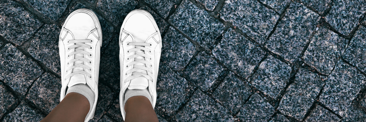Falling on the Ground With MS: An Embarrassing but Funny Story Girl in white sneakers is standing on paving stones
