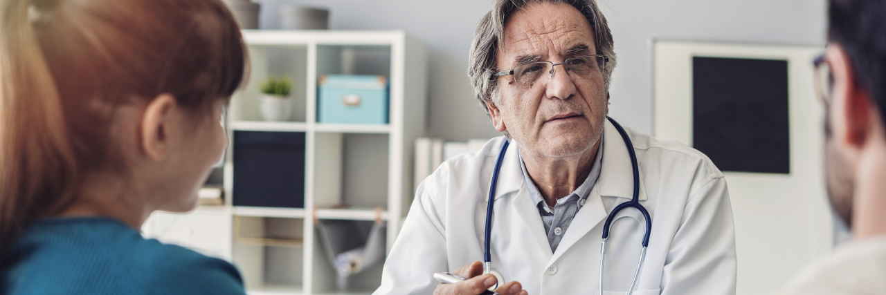 When Doctors Deliver a Rare Disease Diagnosis for Your Child Doctor talking a young couple of patients