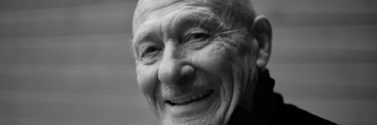 Somehow, It Always Gets Better: My Mental Illness Story Black and white horizontal capture of handsome happy senior expressing positivity and young soul, playing with camera and laughing