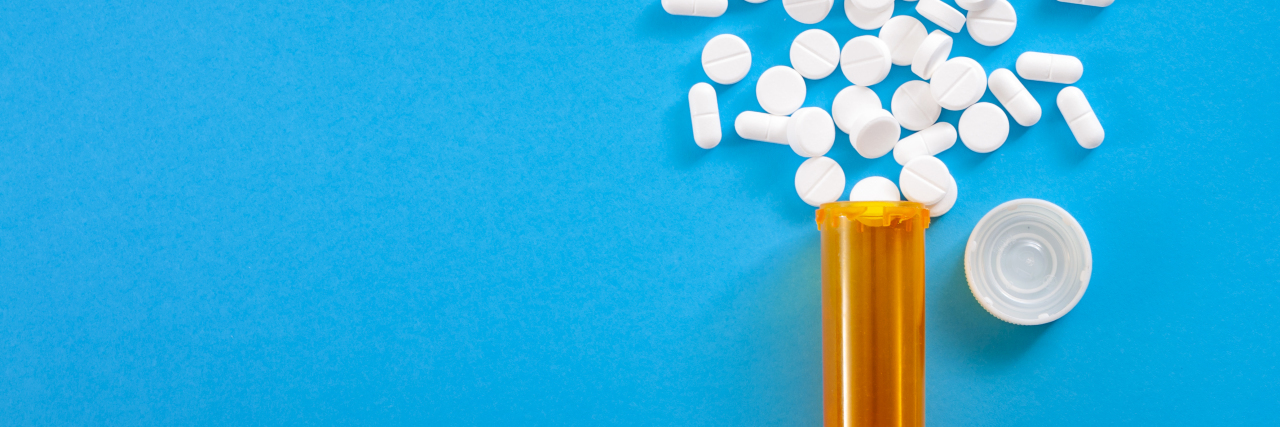 Why Chronic Pain Patients Need Opioids for Pain Management bottle of pills, pills scattered across background