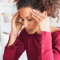 Young black woman suffering strong headache