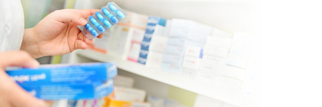Advice for Getting Medication for Beta Thalassemia Pharmacist holding medicine box and capsule pack in pharmacy drugstore.space for text