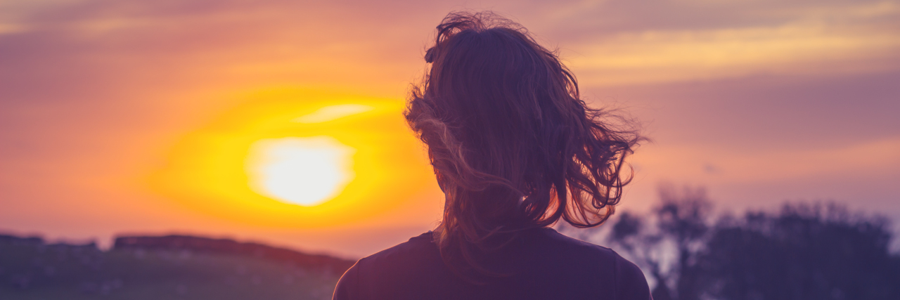 I Still Expect A lot From Myself While Recovering From Cancer a woman is looking at the suset