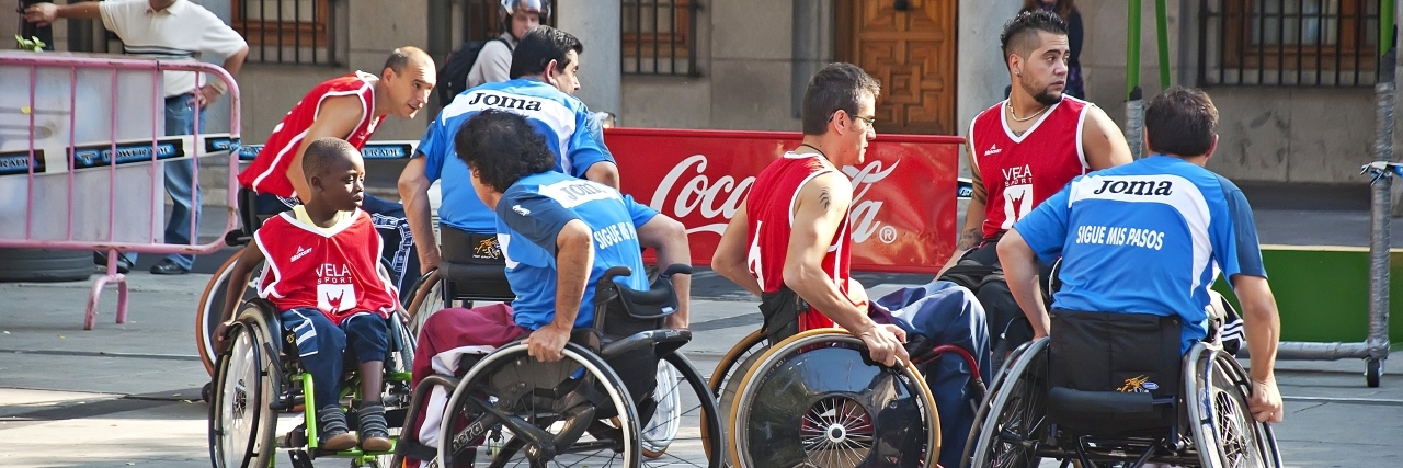 We Need More Adaptive Sports Teams Group of young men playing wheelchair basketball.
