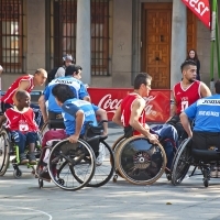 Group of young men playing wheelchair basketball.