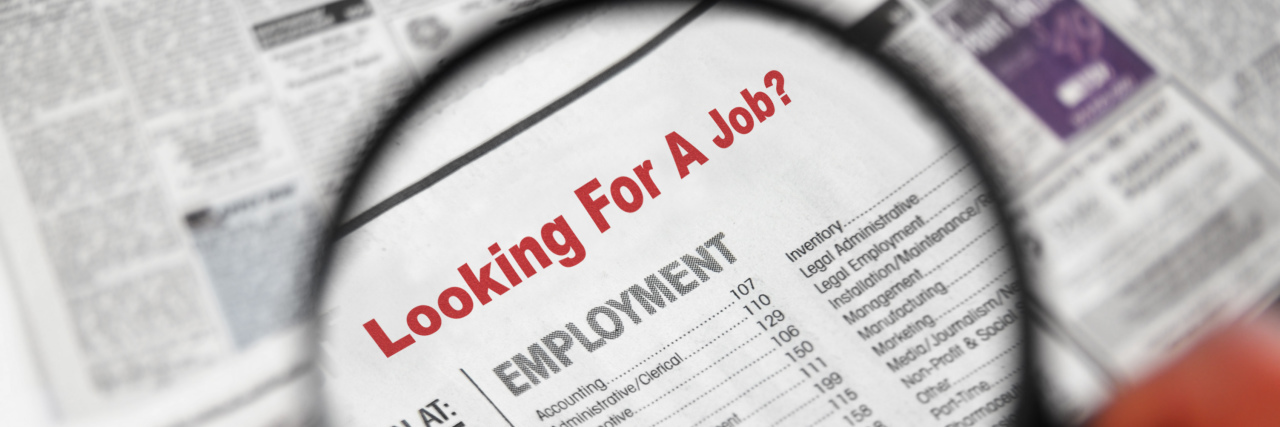 Searching for a Job as a Person With a Disability Magnifying glass over Jobs section of newspaper classifieds.
