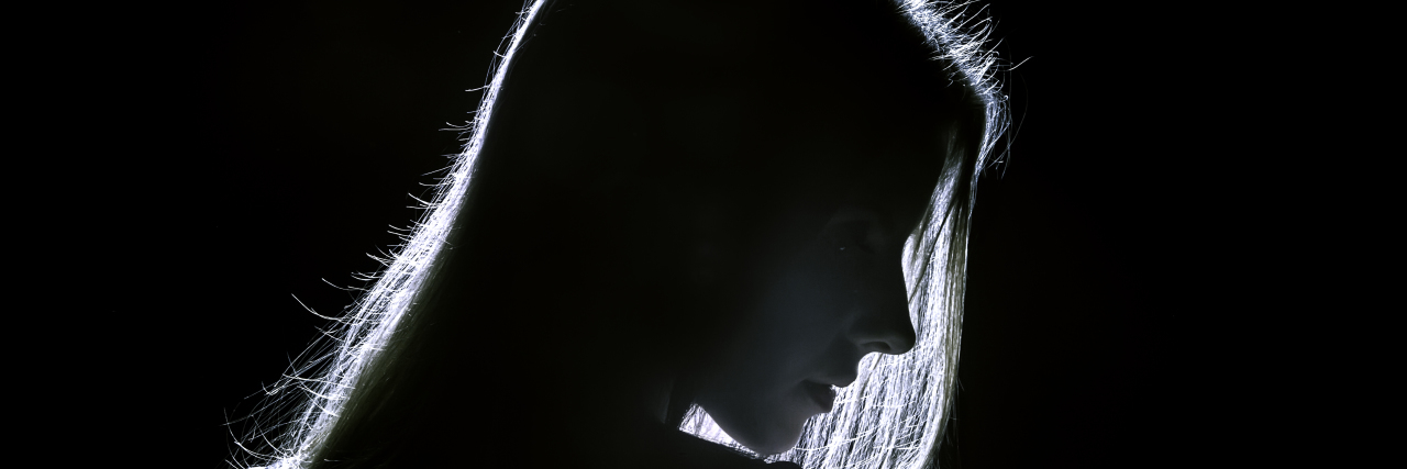 The Invisible Struggles I Face With Autism Silhouette of woman, black-and-white photo.