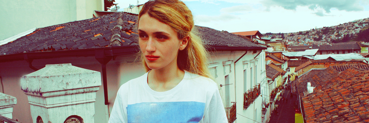 Negative Thoughts That Come From My Mental Illnesses A woman on a balcony
