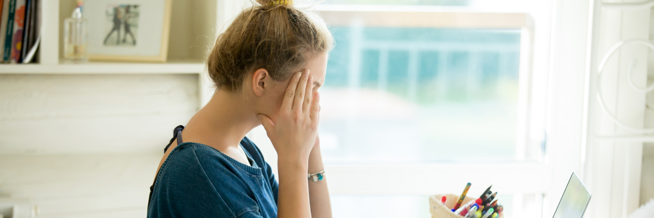 What I Mean When I Say I'm Having a Fibro Flare-Up portrait of a woman sitting at the desk
