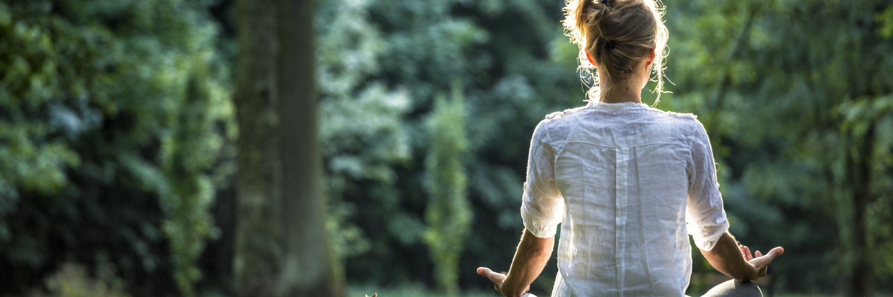 There Is No 'Right Way' to Recover From an Eating Disorder a woman meditating outdoors