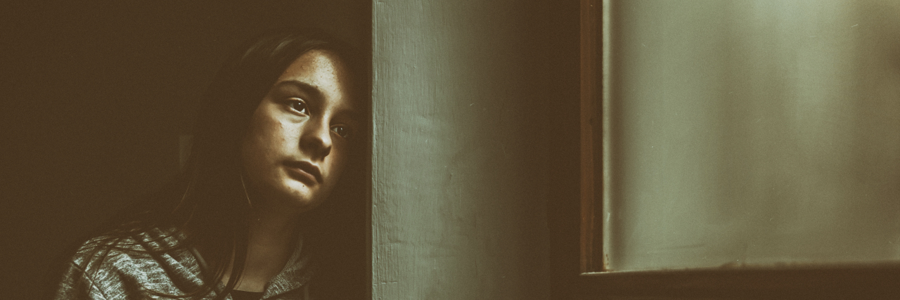 Surviving Bullying as an Autistic Teen Sad and contemplative young woman.