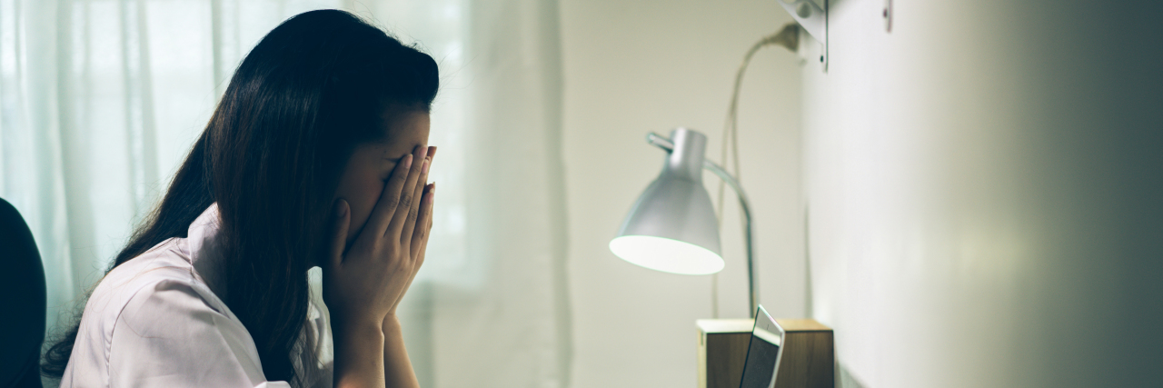 Woman stressed at office desk.