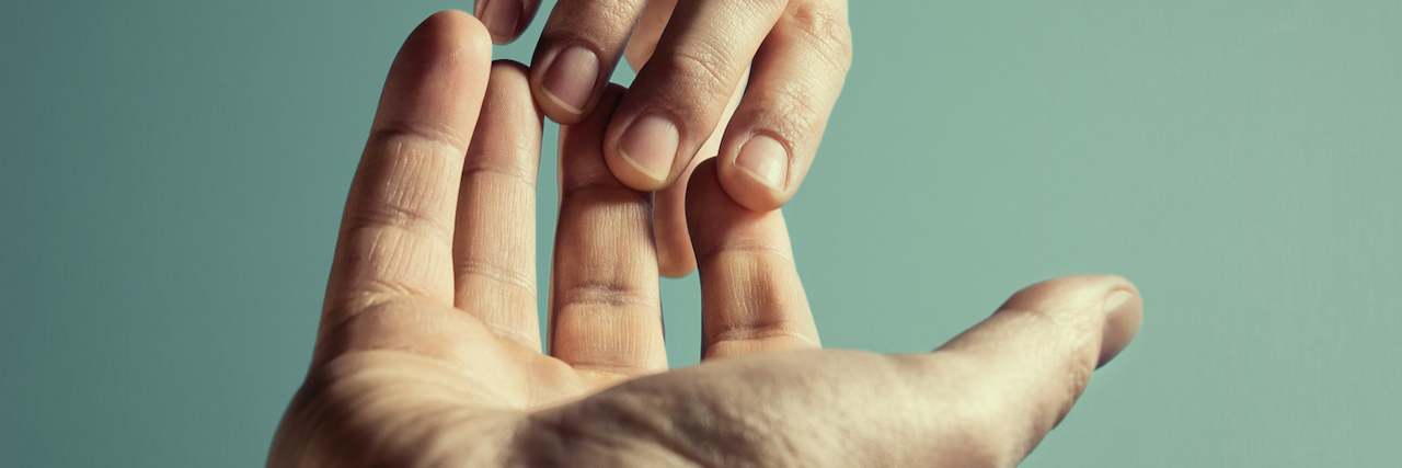Why an OCD Support Group Was Vital to My Recovery A man reaching for another person's hand