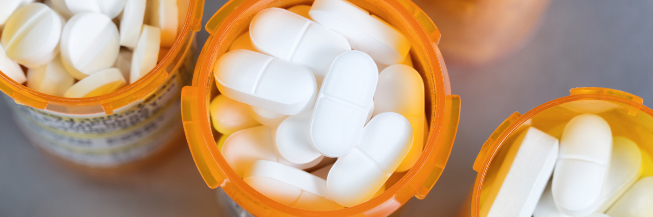 CDC Says 2016 Opioid Prescribing Guidelines Hurt Chronic Pain Patients top view of prescription bottles full of white pills