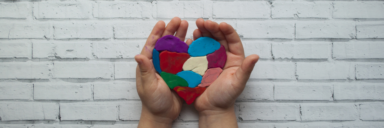 Why Autism Awareness Isn't Enough Child's handChild's hands holding a heart on white background.s holding a heart on white background.