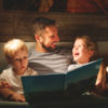 Father reads to his sons.