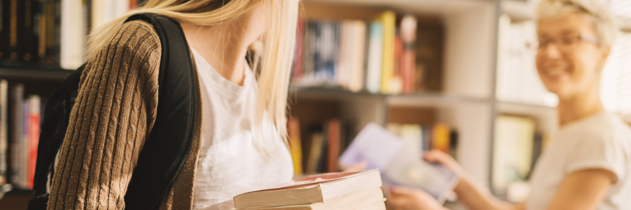 Living With Lipodystrophy: When People Comment on Your Appearance close-up of a girl carrying books and another woman talking to her in a bookstore