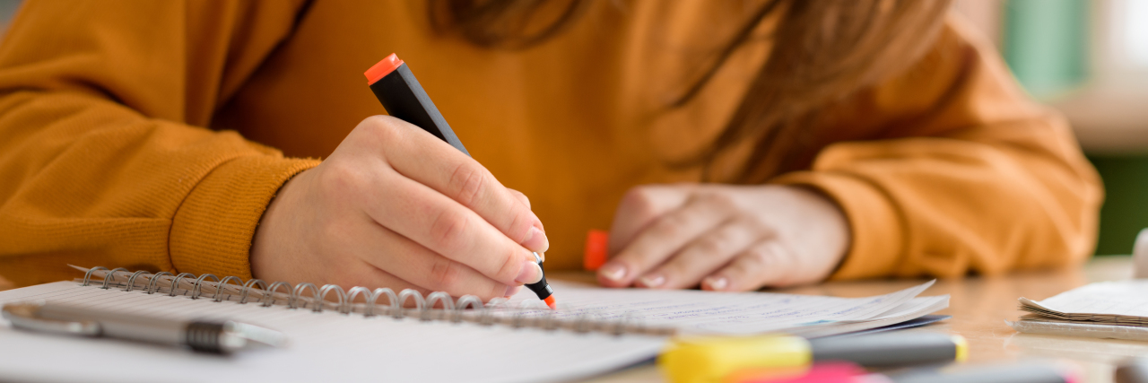 5 Tips for Students With Brain Fog Student taking notes.