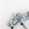 Syringe with medical supplies on blank sheet of paper. 3d illustration