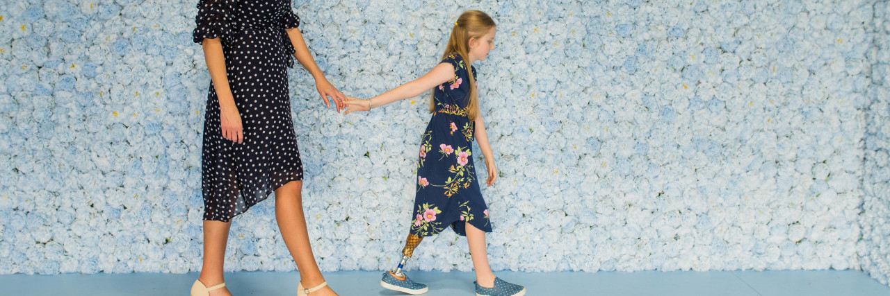 Life After Childhood Limb Amputation Jaimie walking with her daughter Callie.