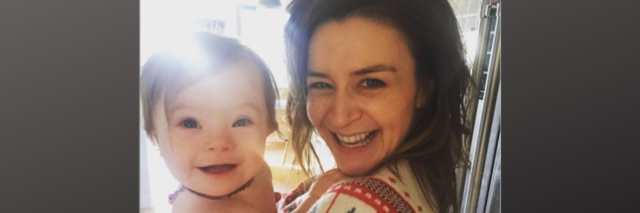 Caterina Scorsone holding daughter Pippa. Both are smiling at the camera.