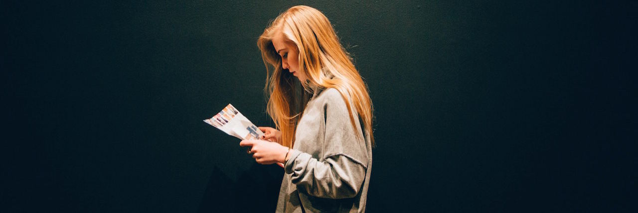 Living With Depression and Trying to Think More Positivity A woman looking at a magazine