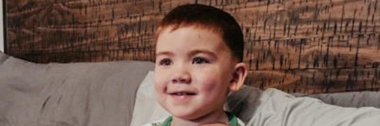 Being a Supportive Sibling to a Child With a Disability the author's son holding his brother, smiling