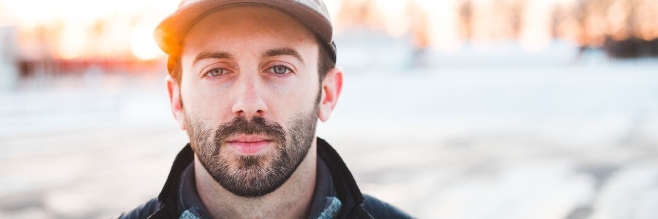 When You Feel Ashamed About Seeing a Therapist photo of man with beard and hat looking serious into camera