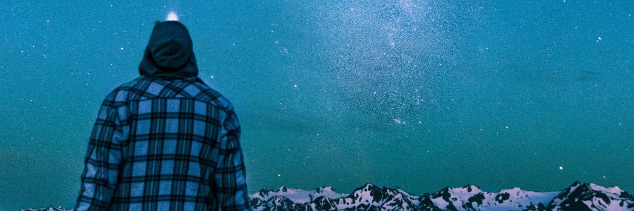 Why I Didn’t Realize I Actually Had Borderline Personality Disorder photo of man sitting in front of mountains and night sky with milky way visible