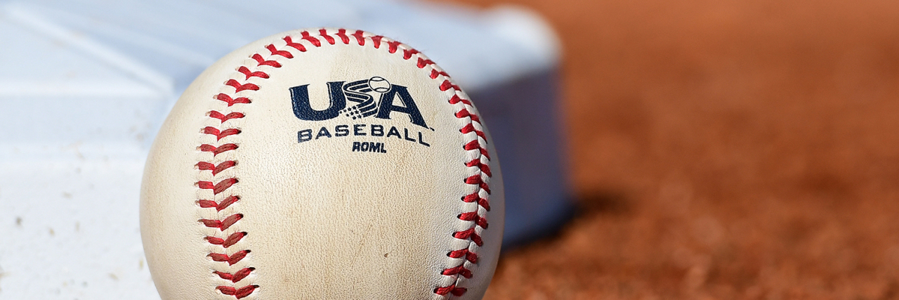 Explaining Wheelchairs to Young Children Baseball next to base on field.
