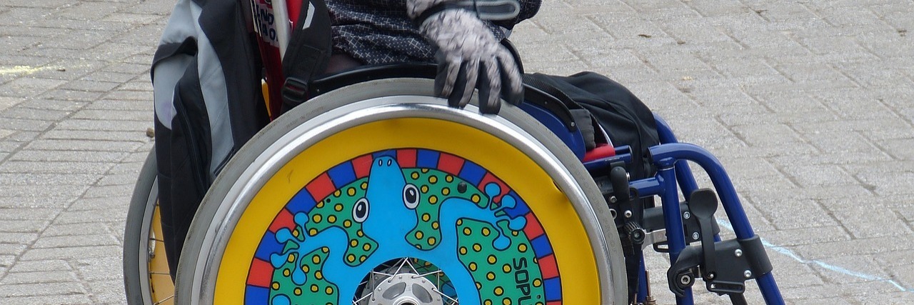 Sydney Mayor Wants to Call Disabled People 'Access Inclusion Seekers' Manual wheelchair user with colorfully-decorated wheels.