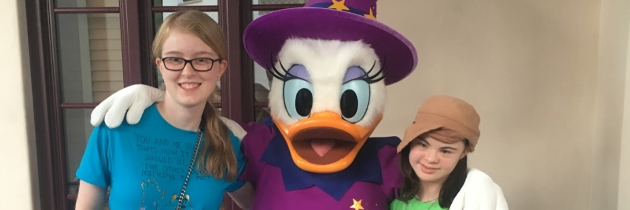 Common Myths About Down Syndrome Friends with a Disney duck costumed character.