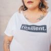 A woman with the word "resilient" on her t-shirt