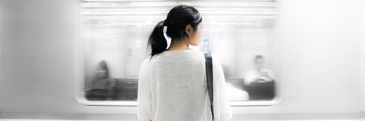 Why Do I Believe I’m Not Good Enough? woman looking at train passing by