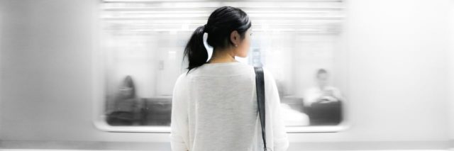 woman looking at train passing by