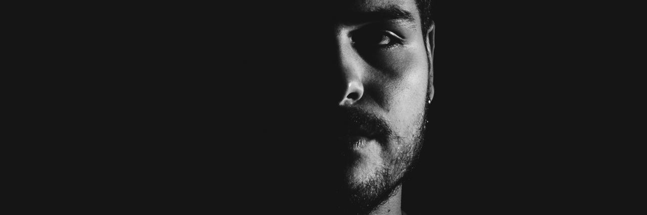 Stop Misusing These Mental Health Labels black and white close up photo of man with beard and sad expression looking into camera