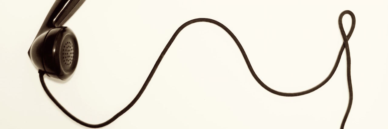 What It's Like to Work for a Mental Health 'Warm Line' A phone with a chord
