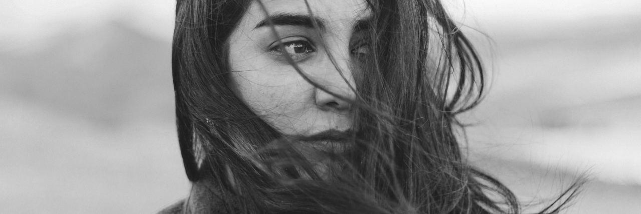 How I Realized Depression Recovery Is a Constant Process black and white photo of young woman looking off-camera