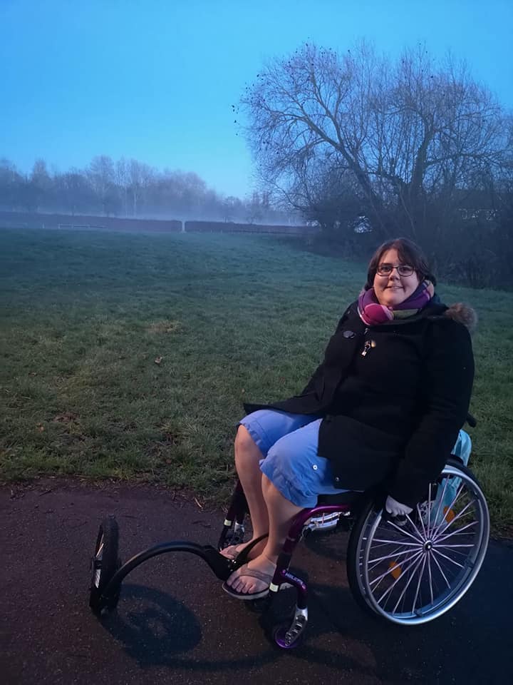 Sophie using her wheelchair with an off-road attachment on the front.