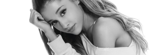 black and white photo of ariana grande kneeling in front of camera