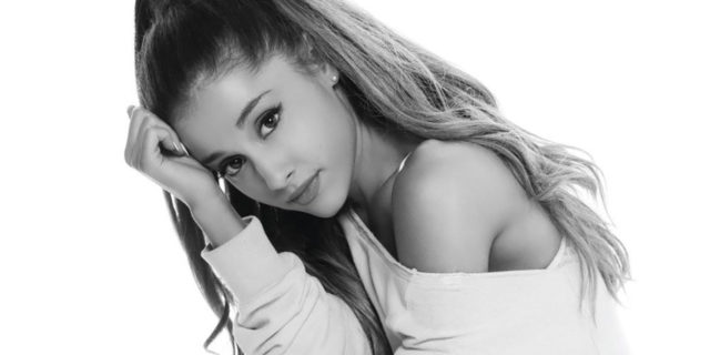 black and white photo of ariana grande kneeling in front of camera
