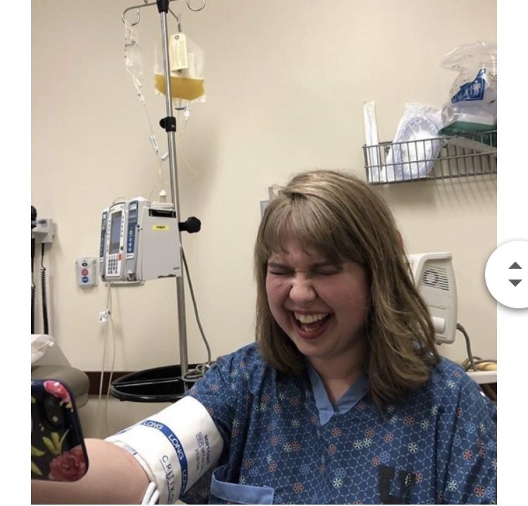 megan smiling, with an IV in her arm