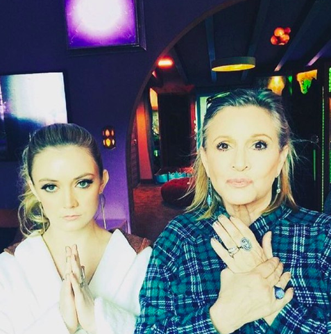 Image of Billie Lourd and Carrie Fisher with their hands clasped